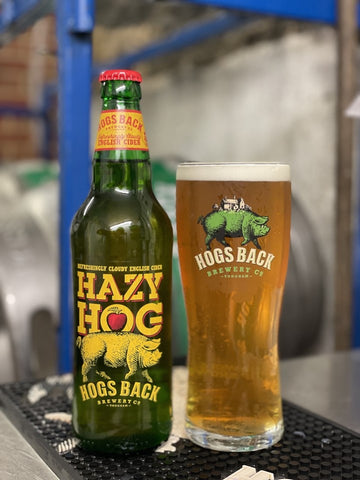 Bottle of Hazy Hog cider and pint glass of cider