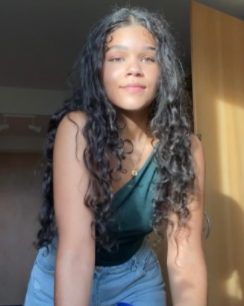 Mixed race girl with curly hair in the sun 