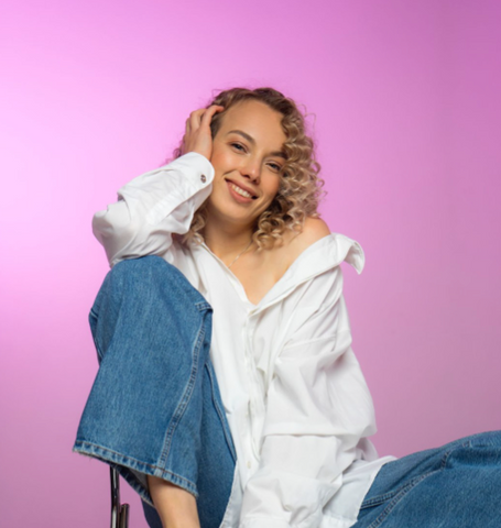 curly hair woman in jeans