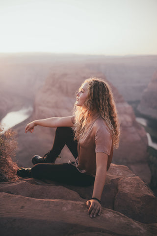 woman blonde curly hair mountain nature