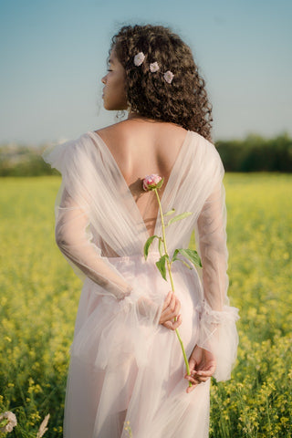 woman with curly hair and flowers