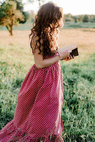woman curly hair reading in summer