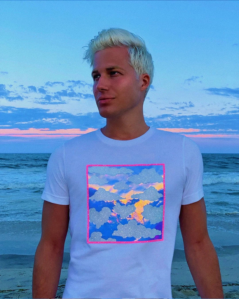 Jason Brickhill wearing Iridescent Cloud Tee on beach during sunset