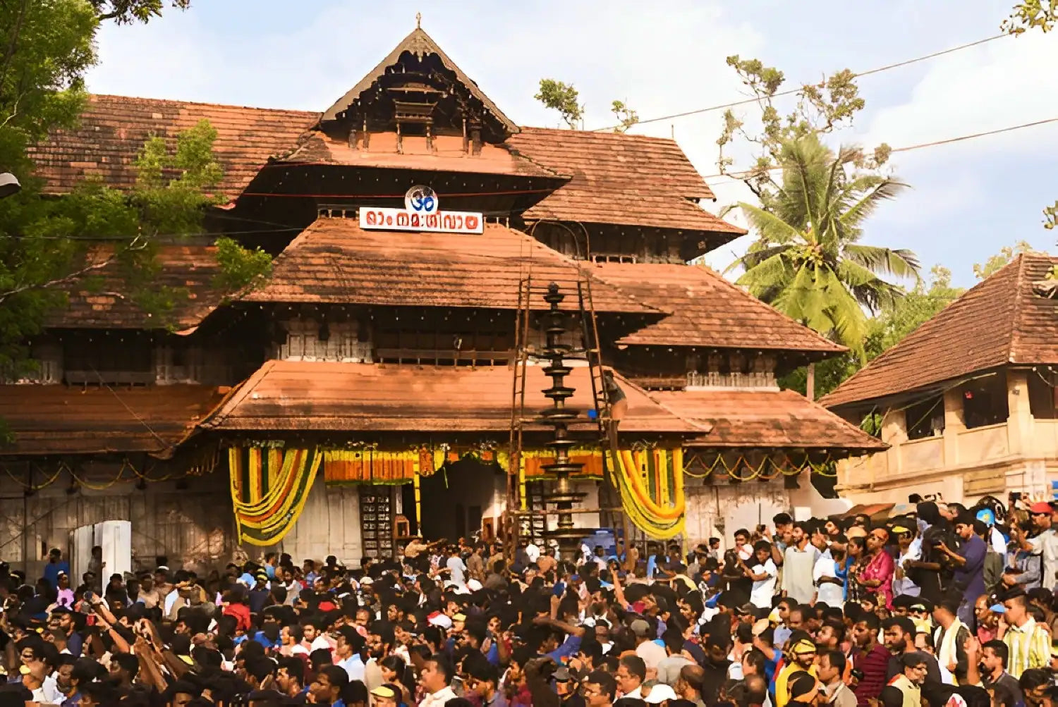 A serene view of Sree Vadakkunnathan Temple, showcasing its historical architecture and lush surroundings during a spiritual journey