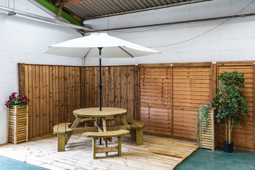 Garden table with parasol surrounded by fencing