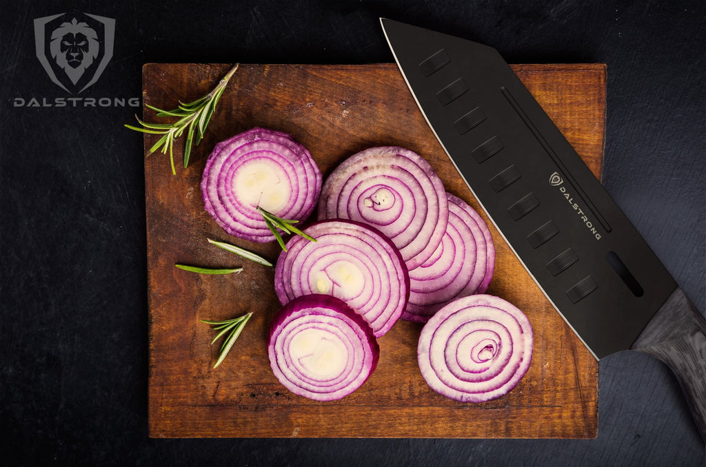 santoku cutting an onion on cutting board