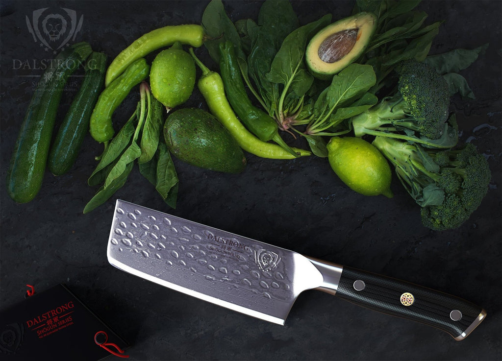 nakiri knife laying beside green veggies