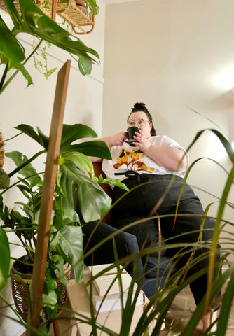 val seated behind plants in Ramona Trousers