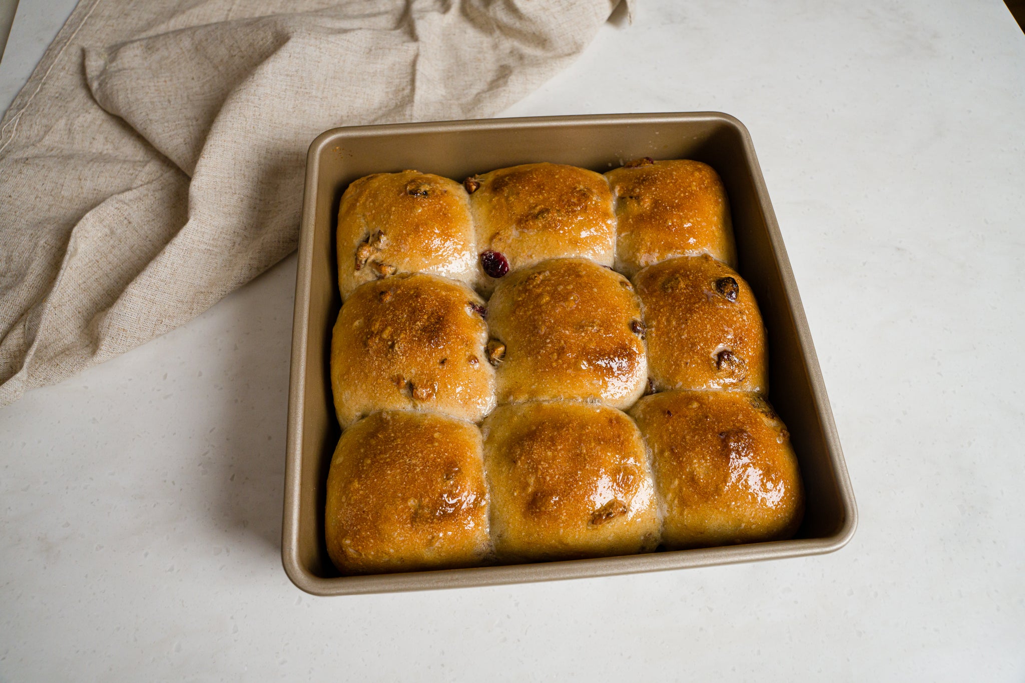 a square pan of freshly baked dinner rolls