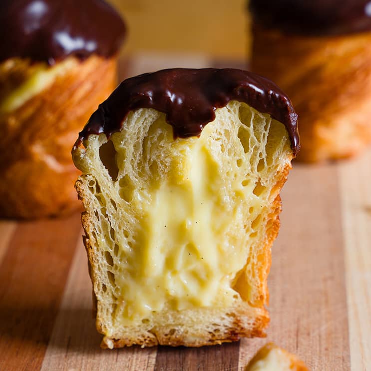 Boston Cream Cruffin halved, showing the filling