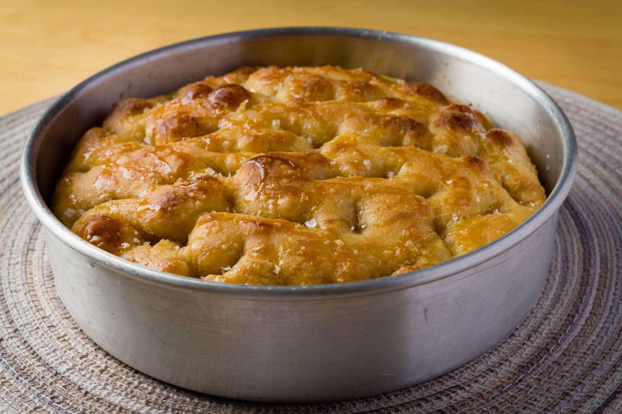 freshly baked focaccia in a round baking pan