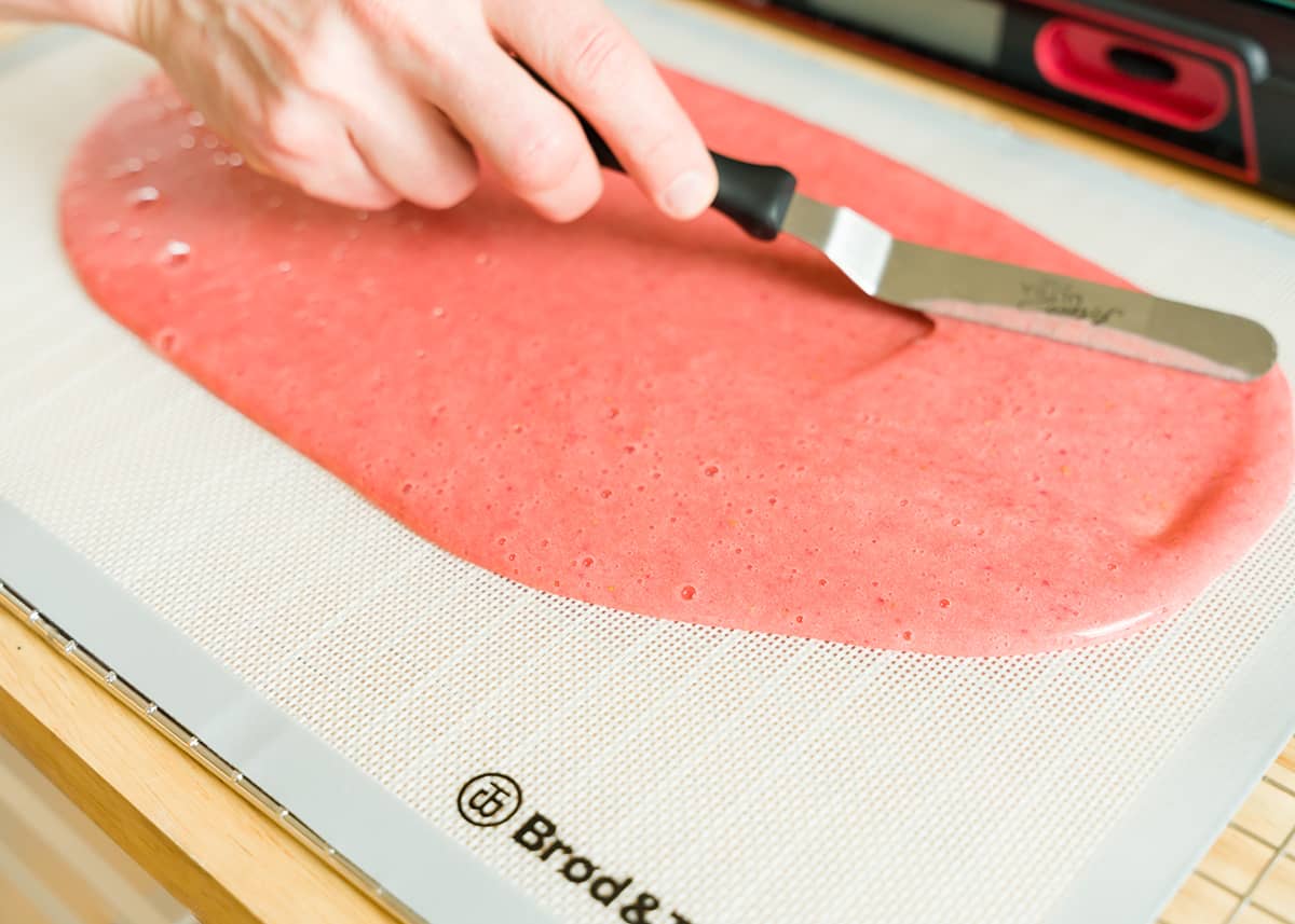 Spreading fruit puree onto the silicone mat