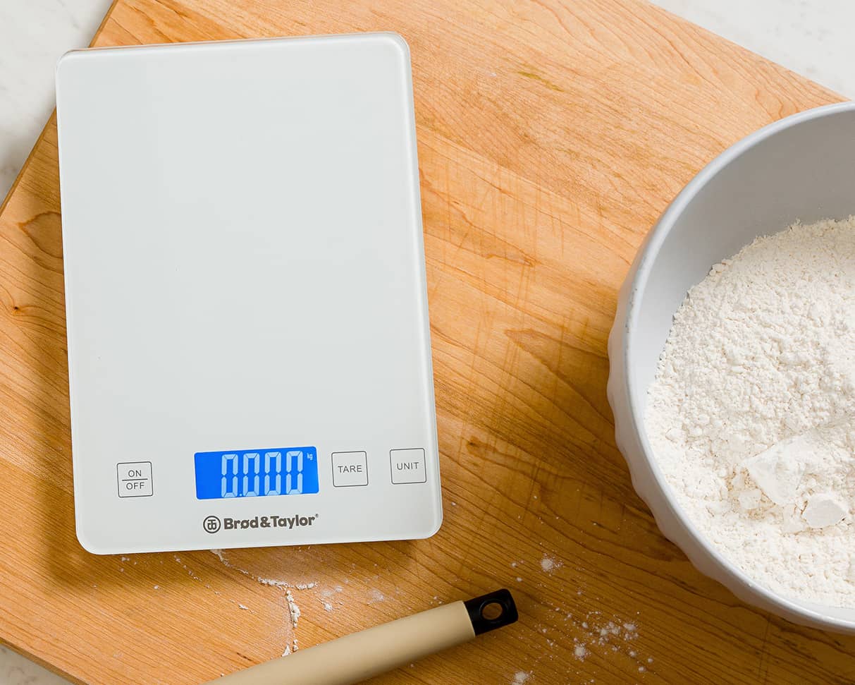 Kitchen scale weighing flour or polenta in glass bowl