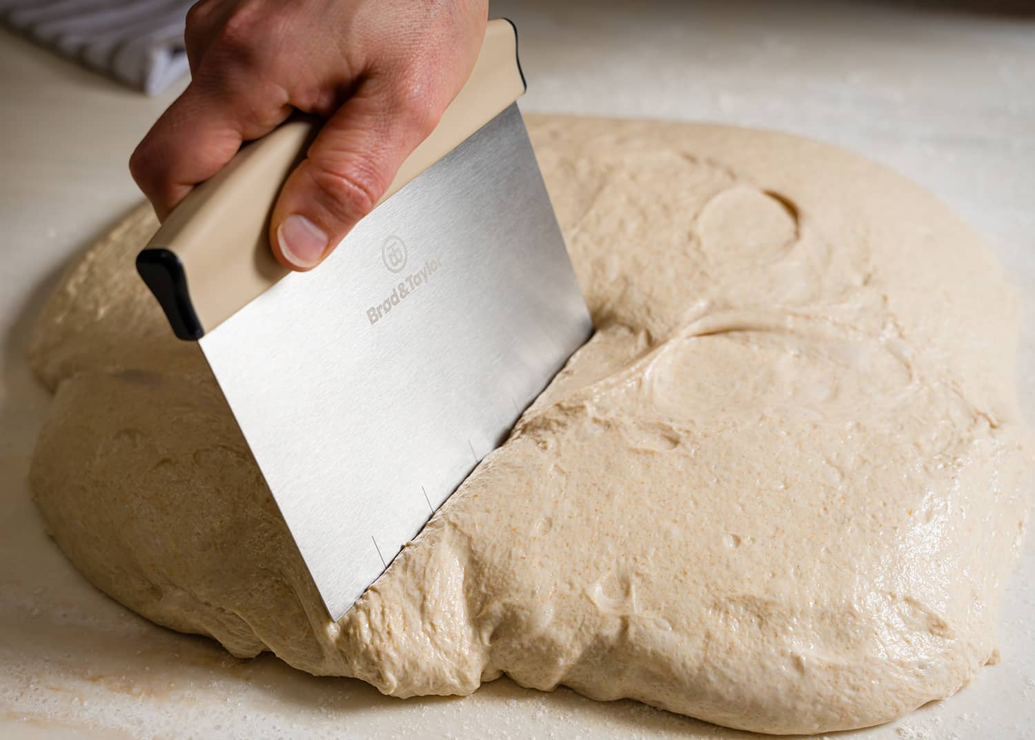 Bench Knife being used to slice dough