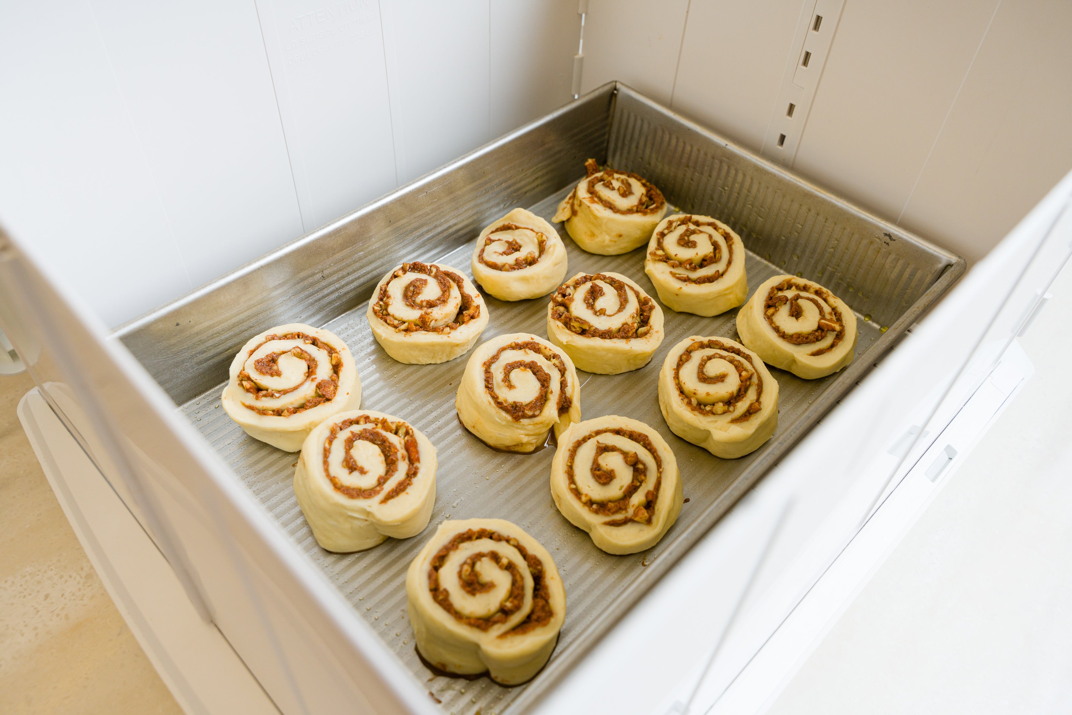 Cinnamon rolls in a rectangular pan inside of the Proofer to rise