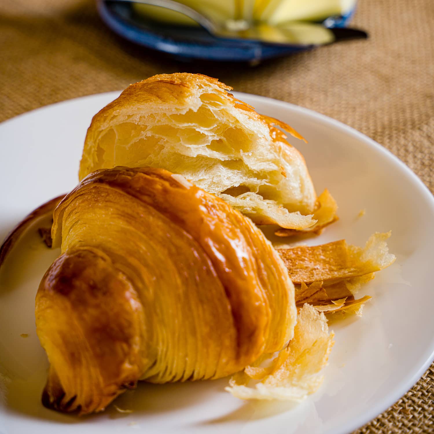 Flaky plain croissant on a plate