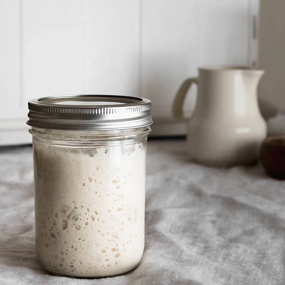 Mature sourdough starter in a glass jar
