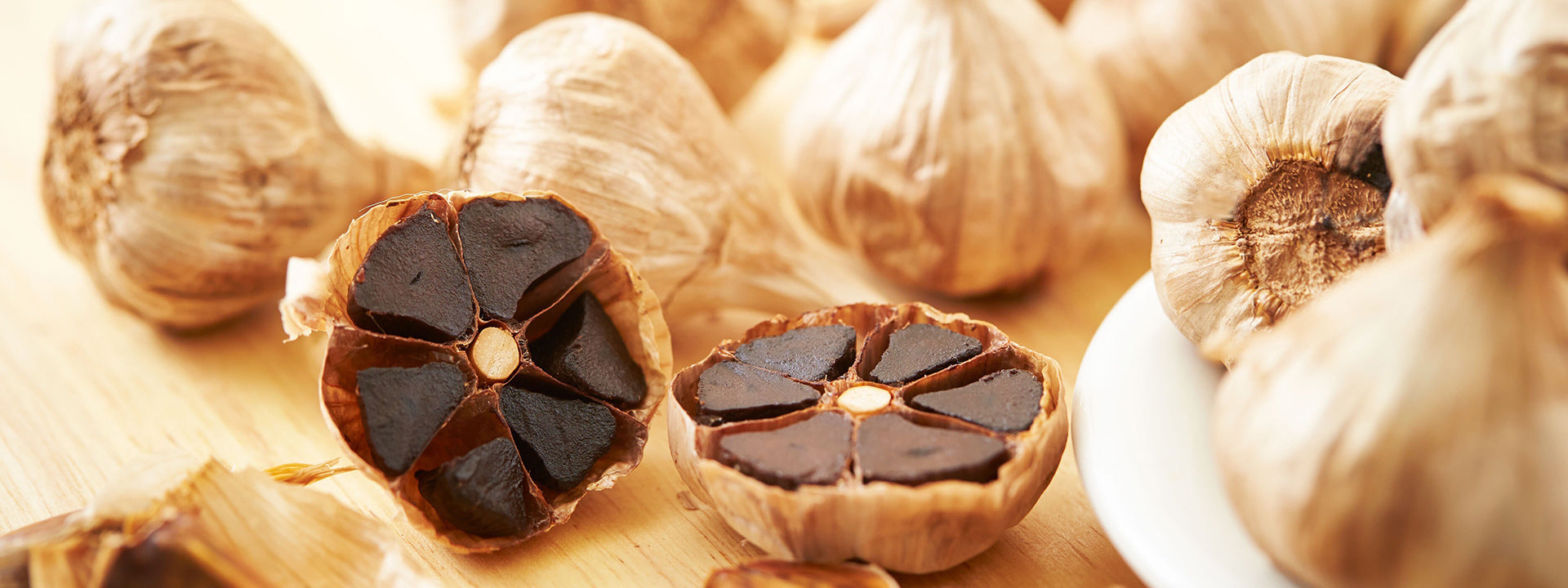 Sliced black garlic bulb and peeled cloves