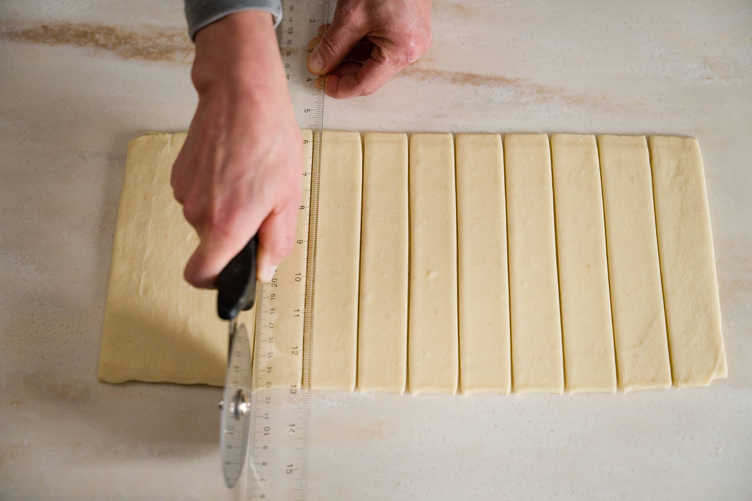 Dough being cut into 12 strips