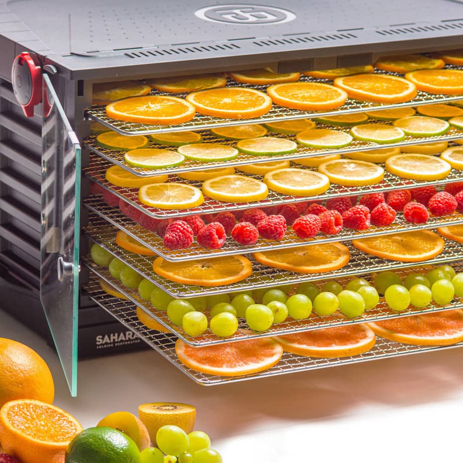 Colorful fruit placed on stainless steel trays in the Sahara Dehydrator