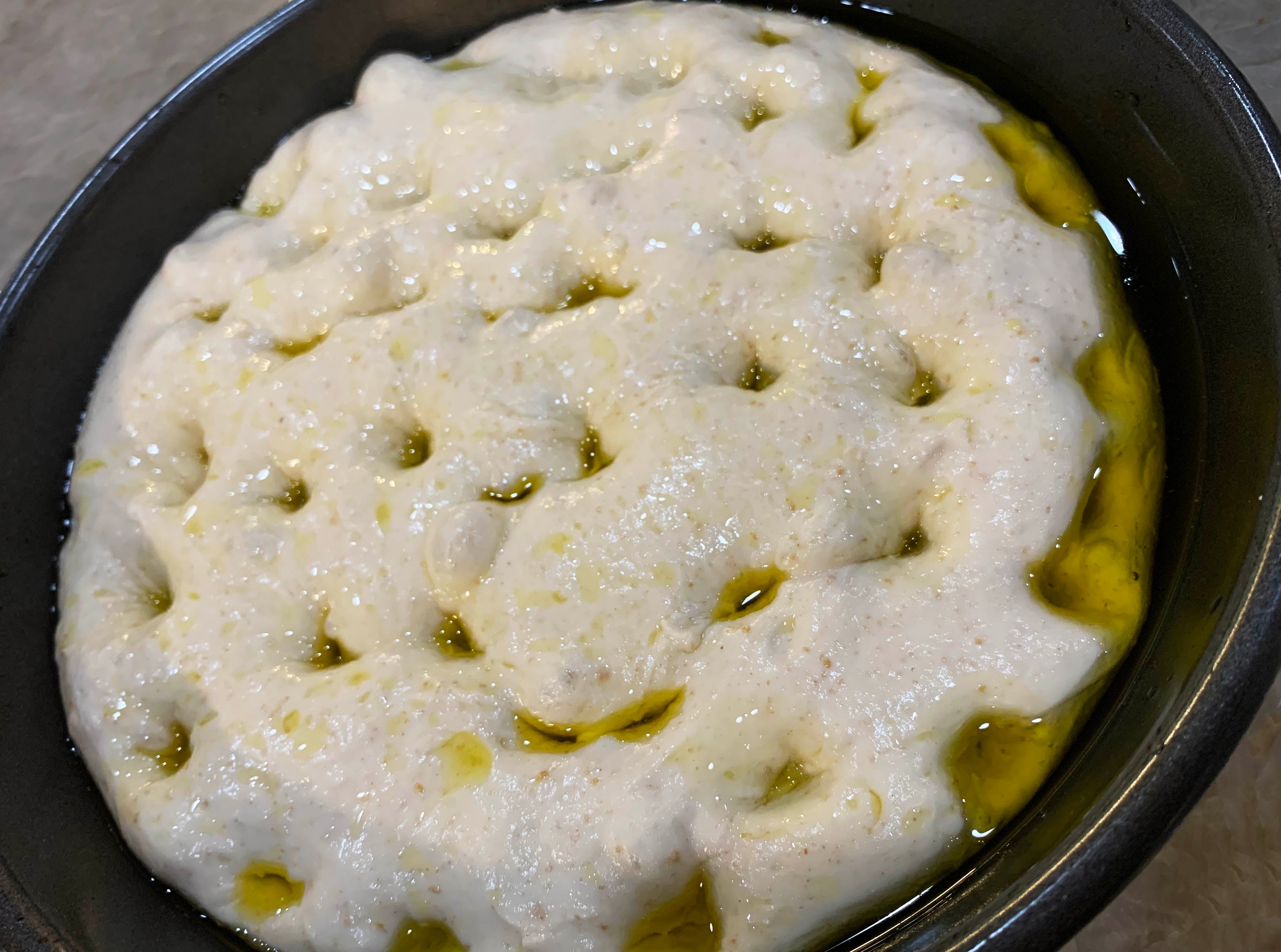 Dough dimpled and covered with olive oil