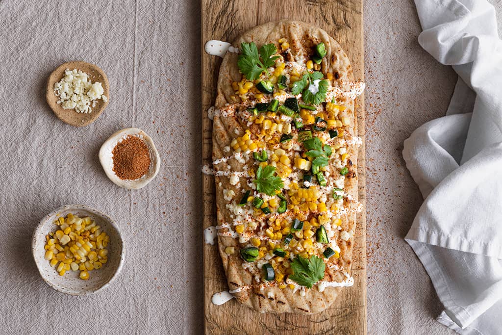 grilled pizza topped with elote