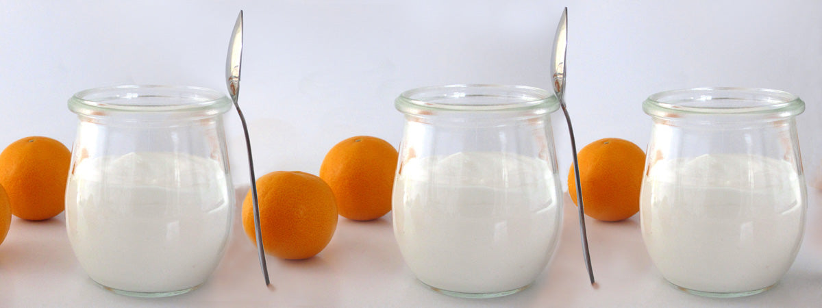 Jars of yogurt and clementines