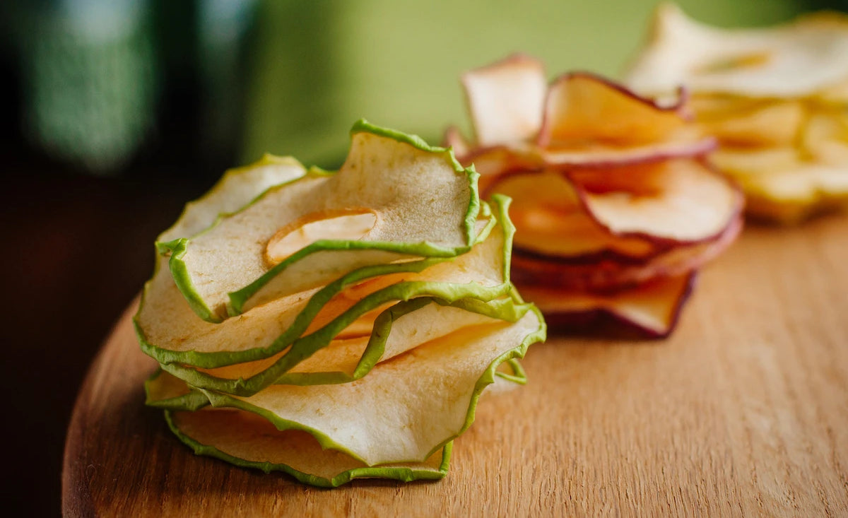 Dehydrated apple chips on wood table