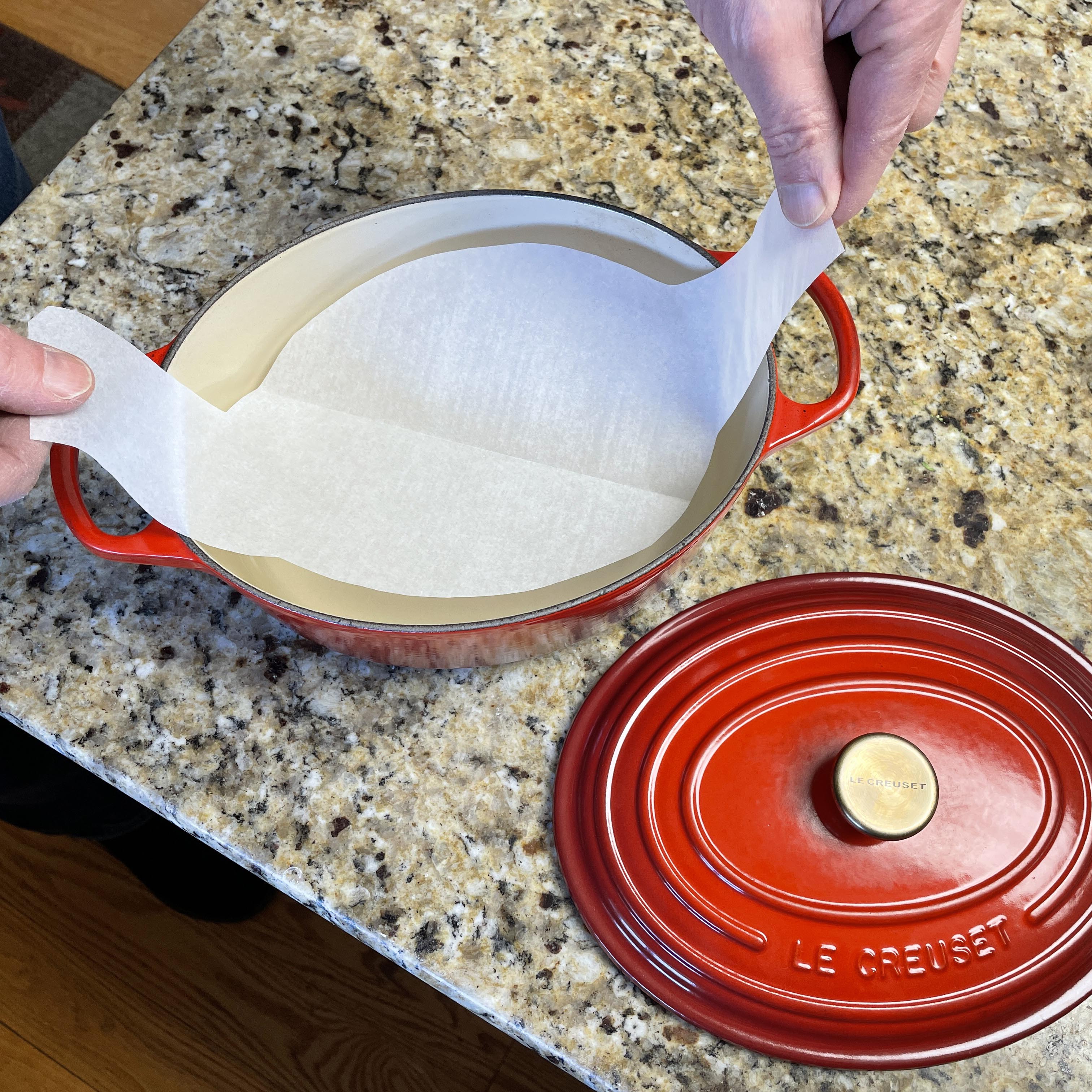 Placing parchment paper on the Dutch oven