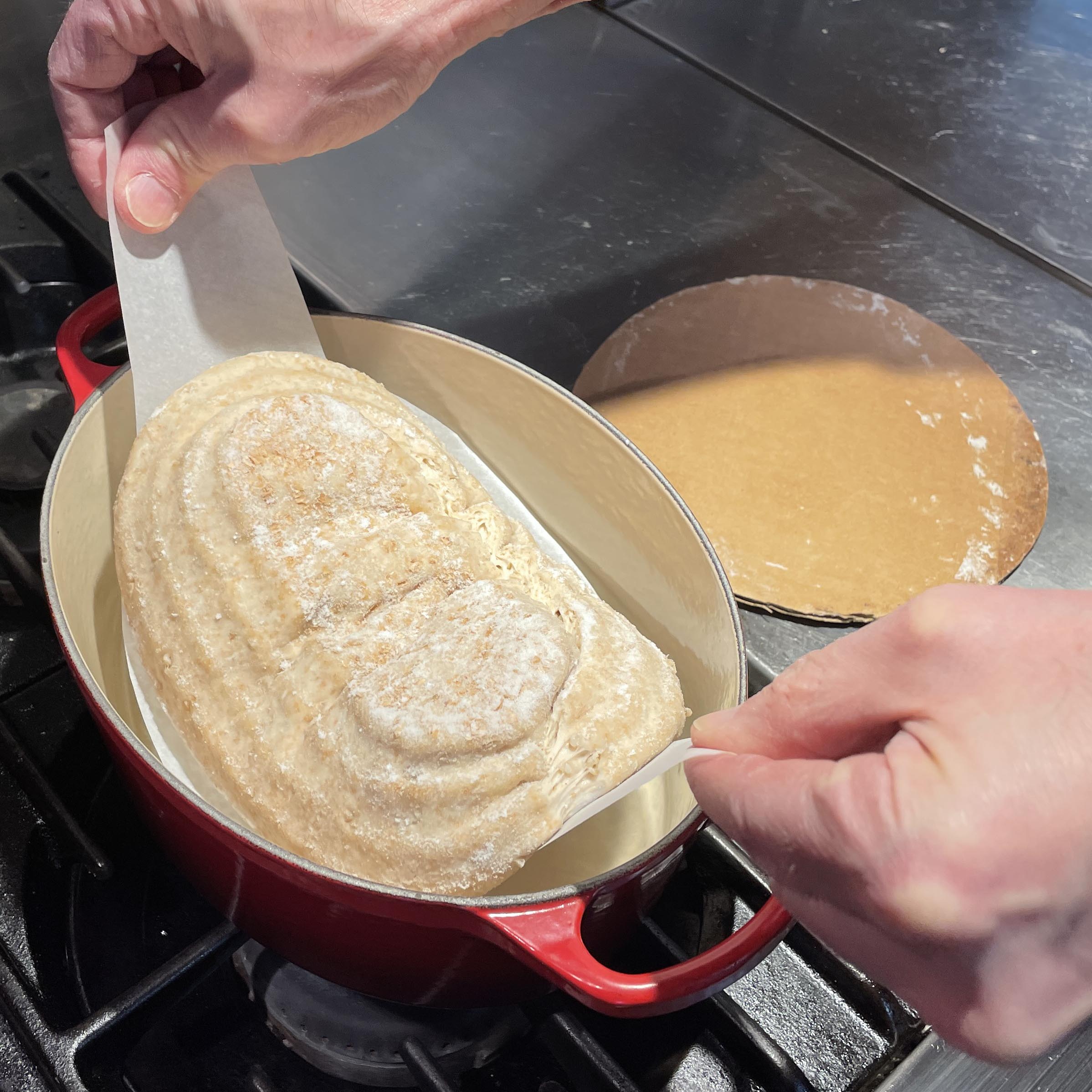 Lifting the dough by parchment paper sling