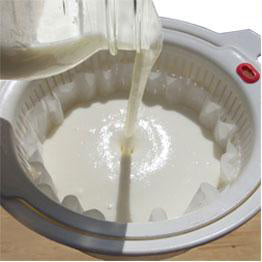 Pour yogurt into lined strainer