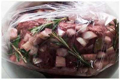 Chuck roast in a large plastic bag being marinated overnight