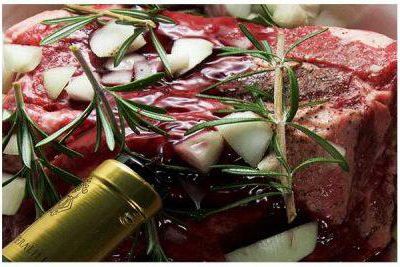 Pouring wine over the prepared roast