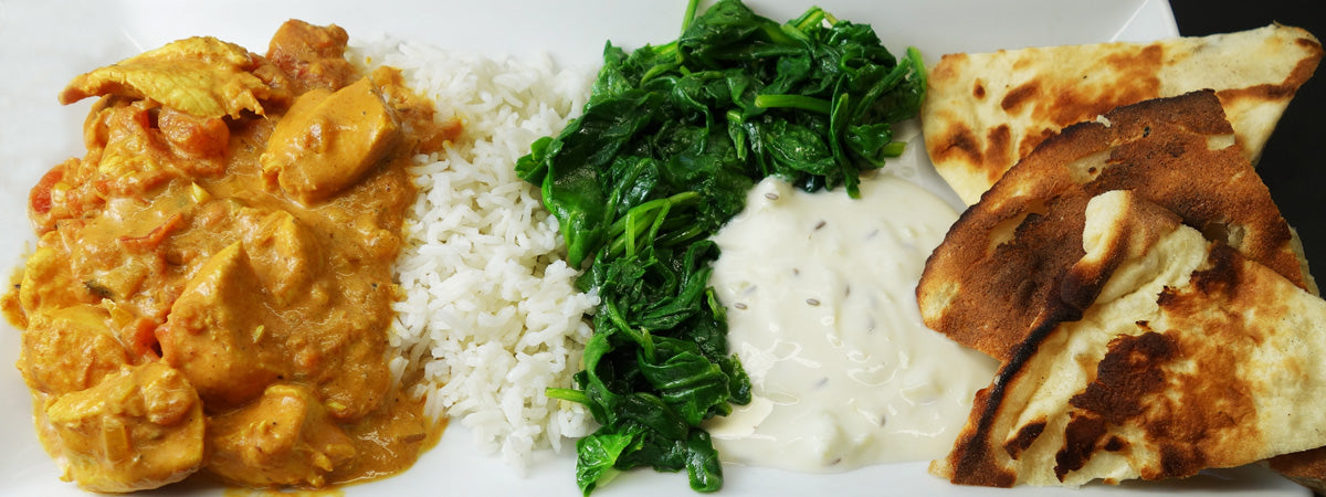 Slow cooked chicken tikka masala, rice, vegetables, and sauce