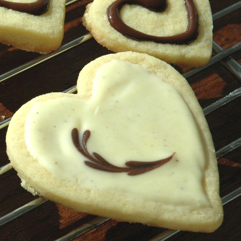 heart shaped cookies decorated with melted white and milk chocolate