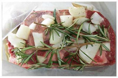 Preparing the chuck roast with onion and rosemary