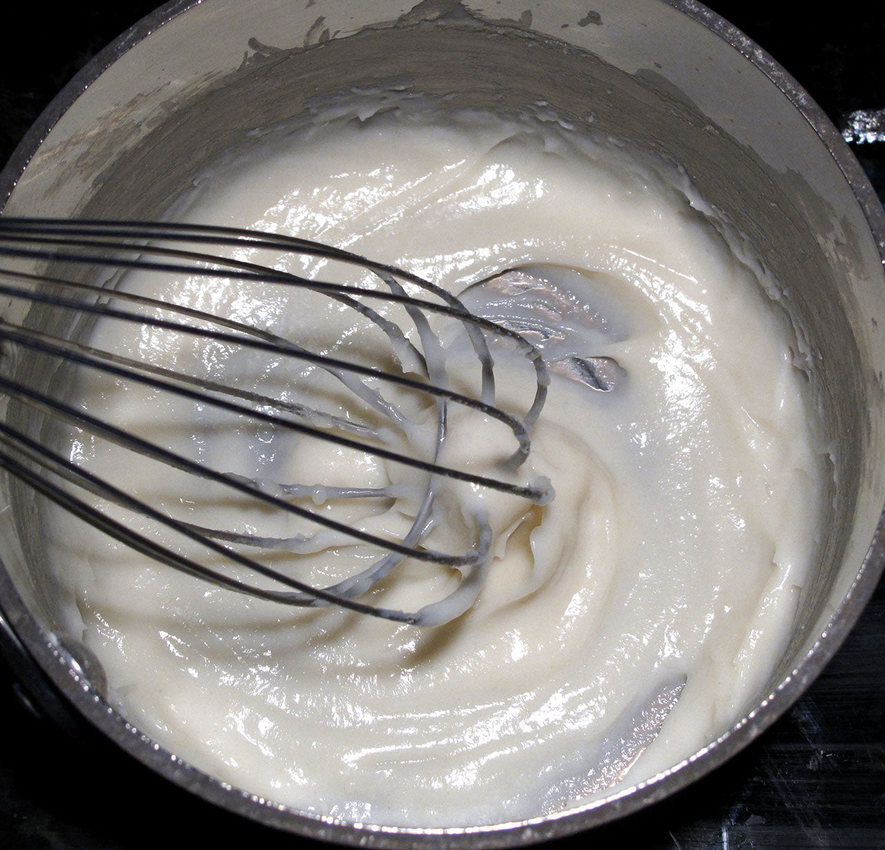 whisking the roux in a saucepot