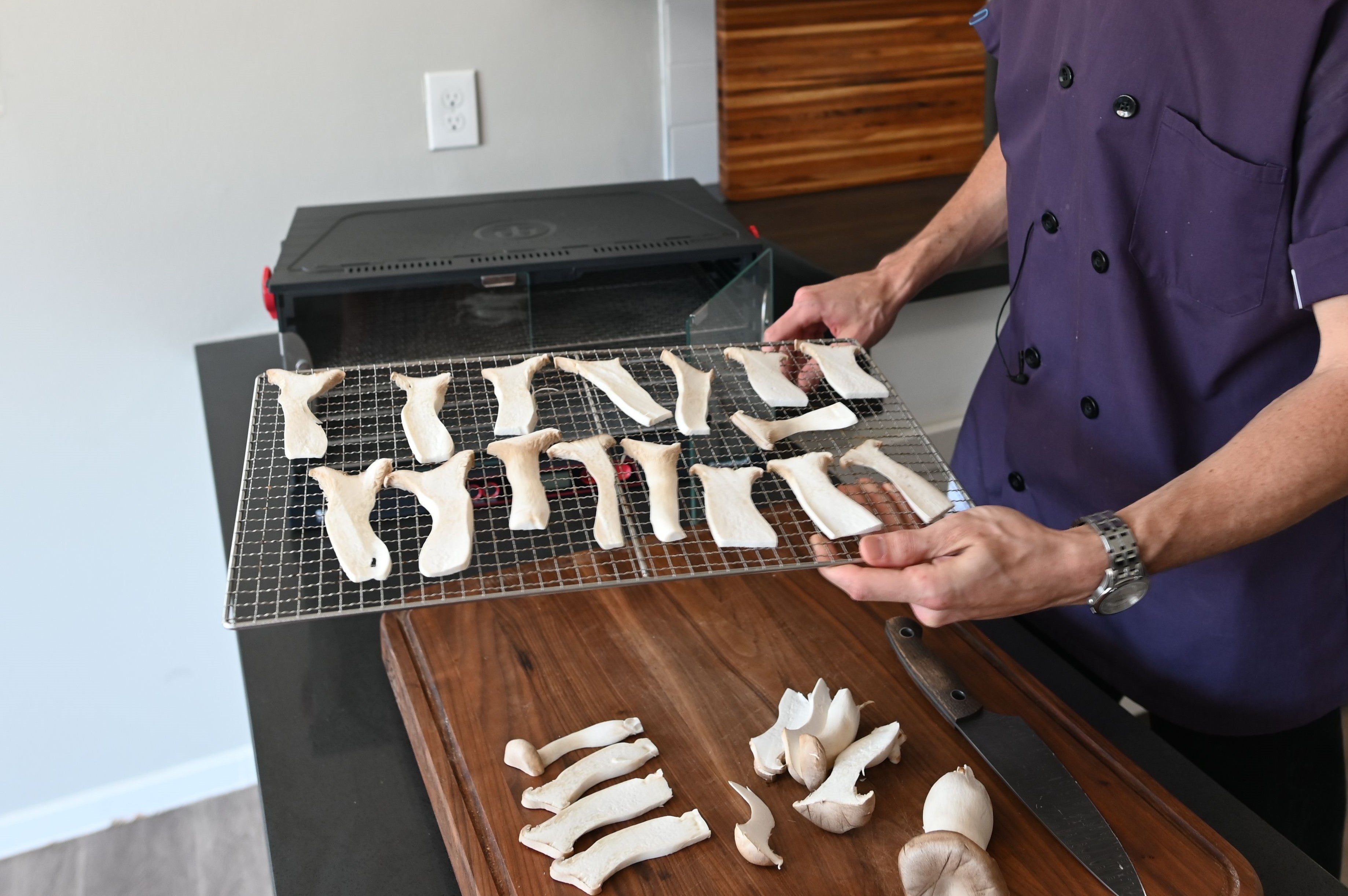 King oyster mushrooms sliced on dehydrator racks