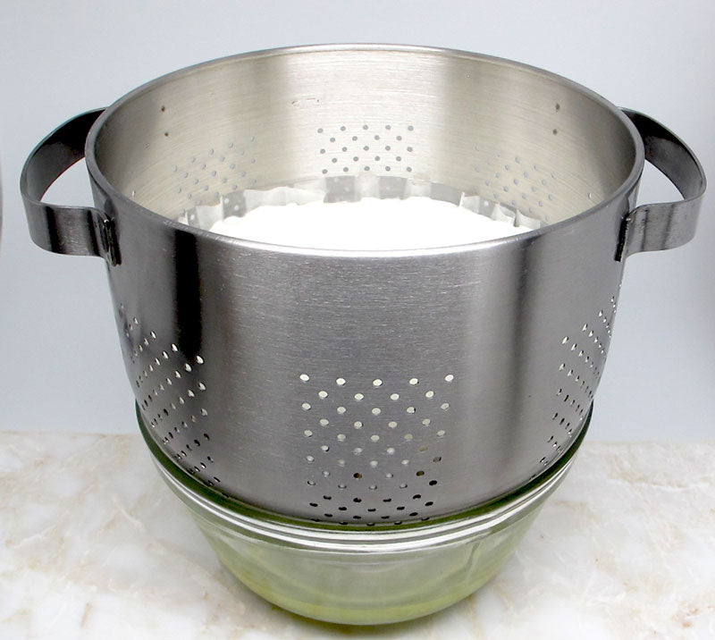 Straining greek yogurt with a stainless steel strainer