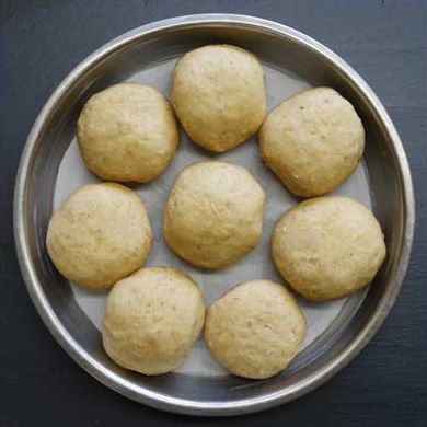 Place the shaped dough ball into a round cake pan