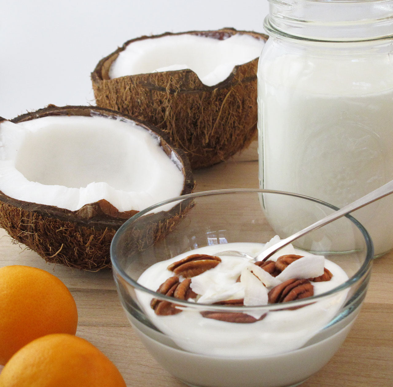 coconut halves and a bowl of coconut milk yogurt