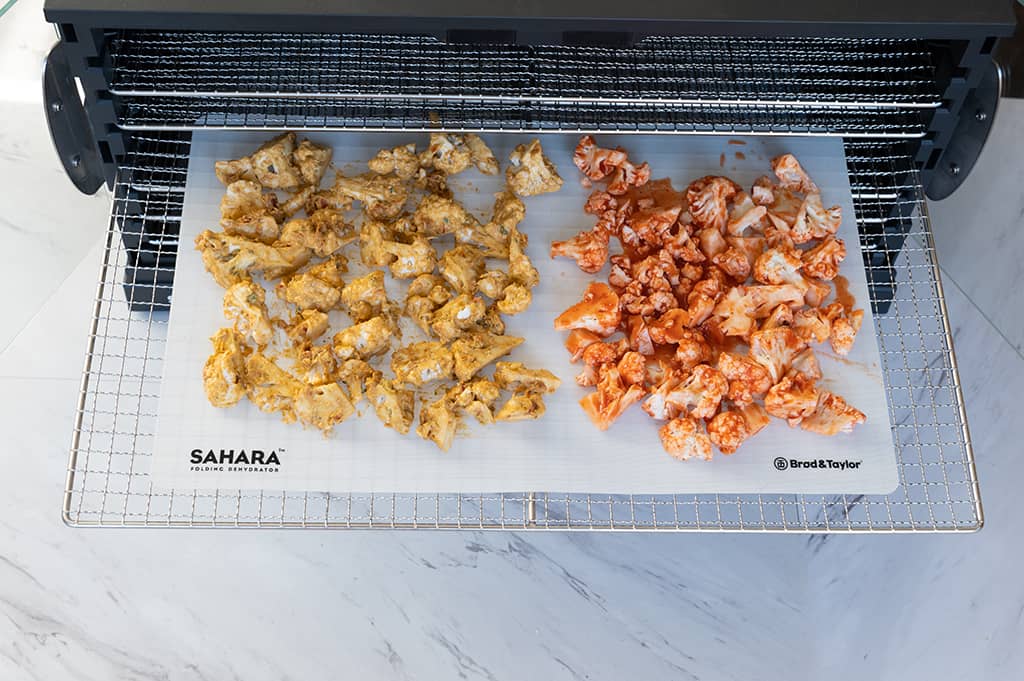 Chopped cauliflower blended and mixed with the spices, into the Sahara Dehydrator