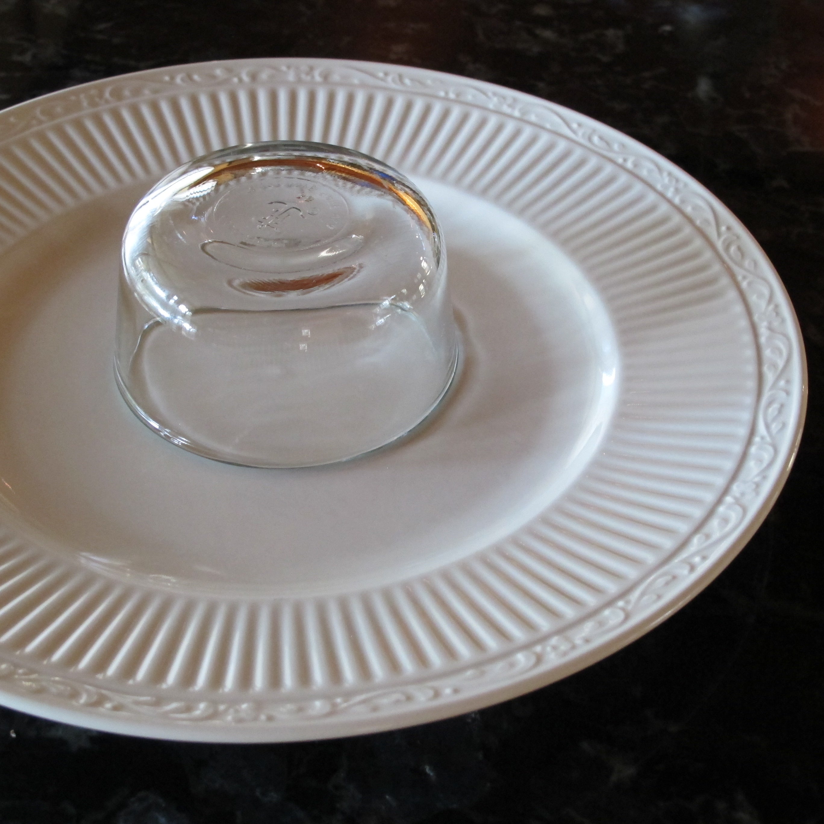 Small glass bowl on a plate