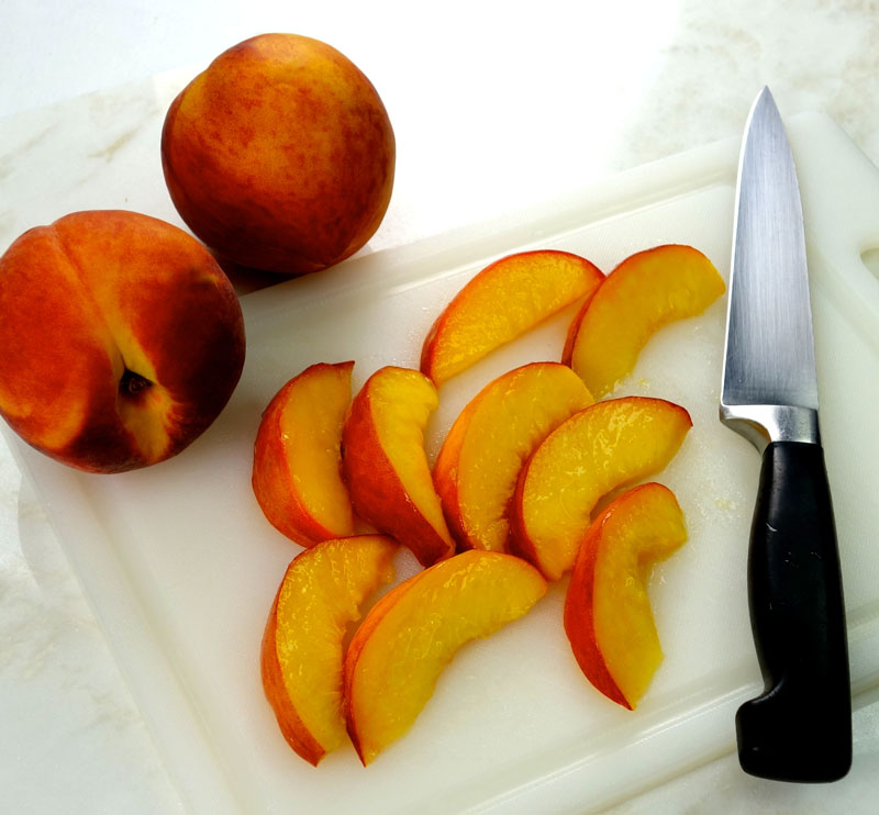 whole and sliced yellow peaches