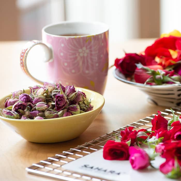 Dehydrated rosebuds and tea in a mug