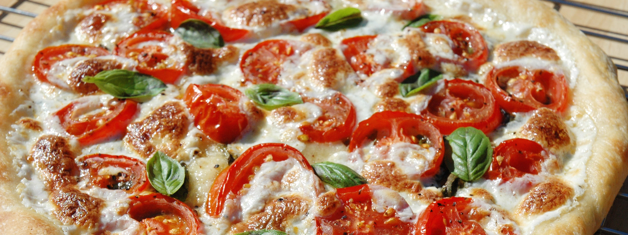 Fresh homemade tomato mozzarella basil pizza