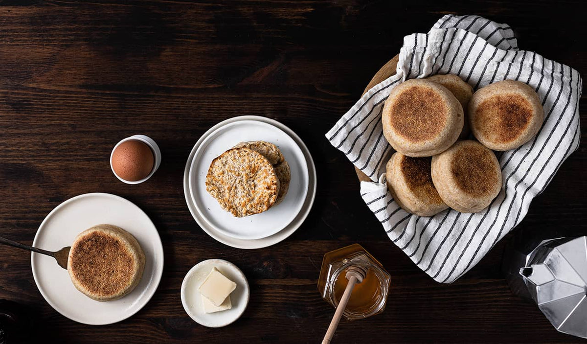 Sourdough English Muffins with butter and honey on the table