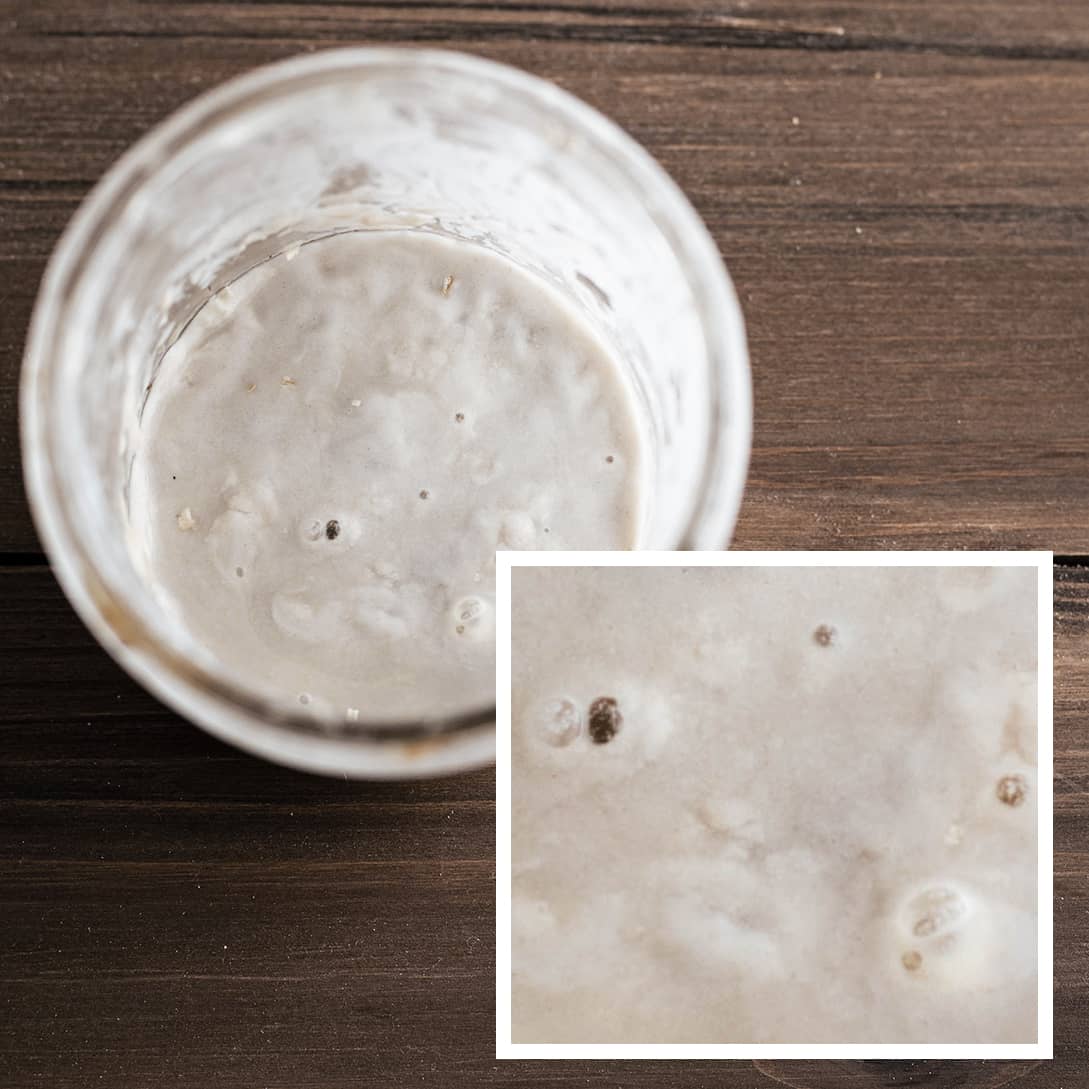 Jar of sourdough starter with hooch on the surface