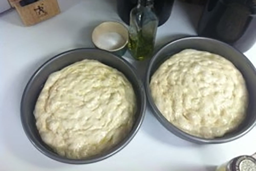 Stretched dough is ready in 9″ cake pans.
