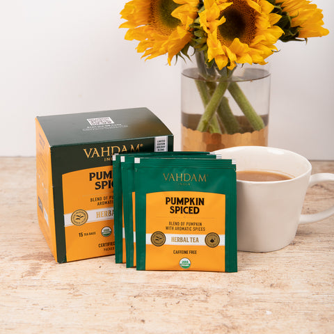 Pumpkin spice tea with green and yellow box with individually packaged tea bags